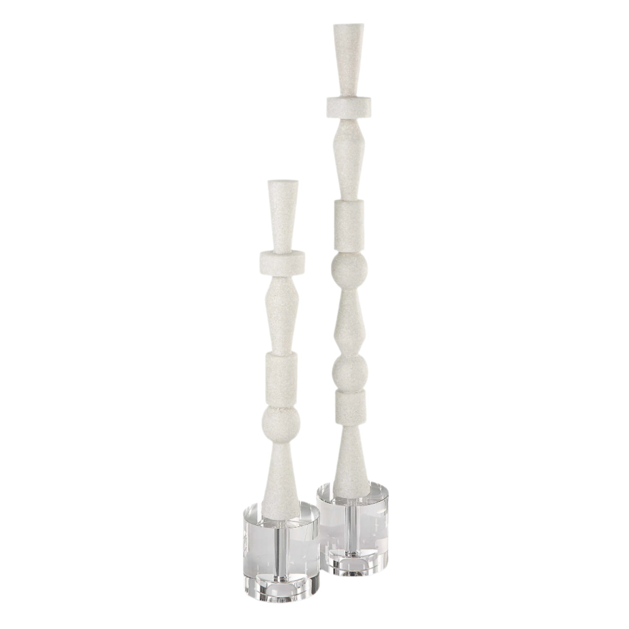 A set of two white sculptures with crystal feet, designed to resemble a stacked totem pole.
