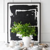 Solo black artwork on table with white wall behind