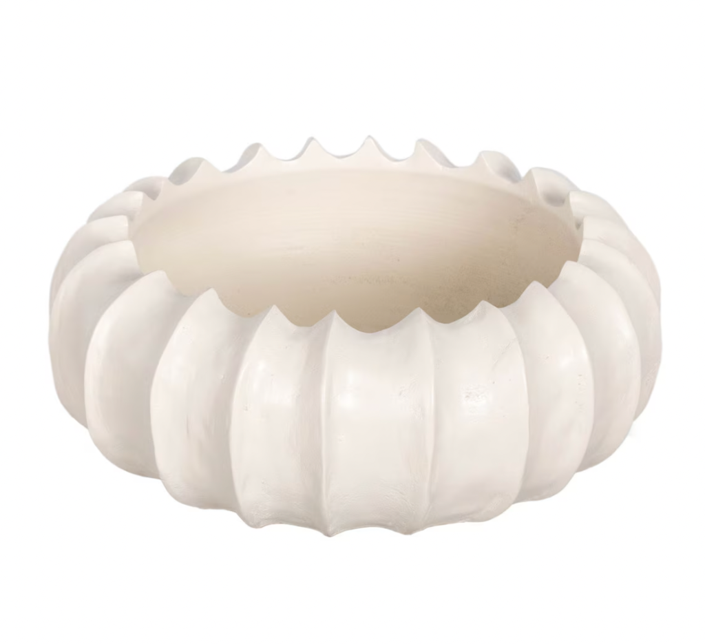A beige scalloped carved wooden bowl on a white background.