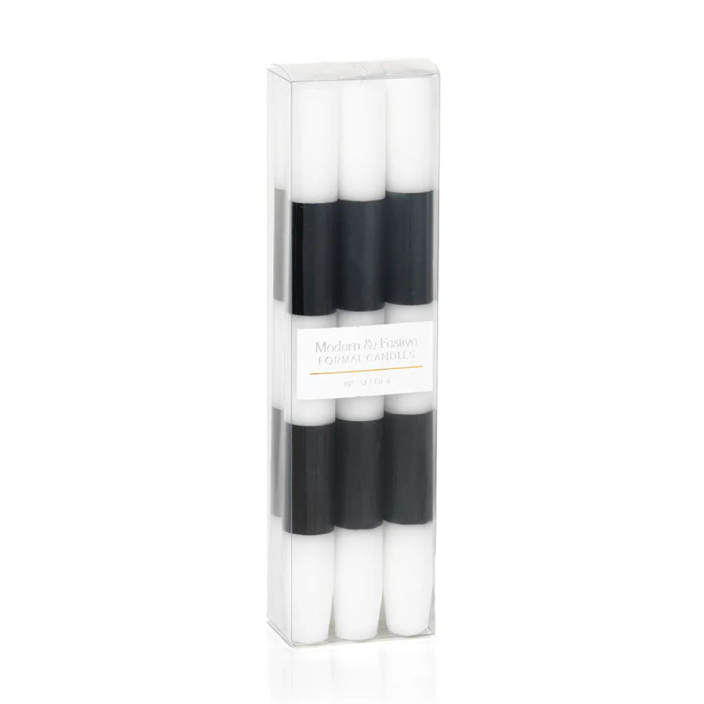 Set of four black and white candles in a clear packaging box on a white background