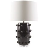 Black lamp with textured design and white shade on a white background