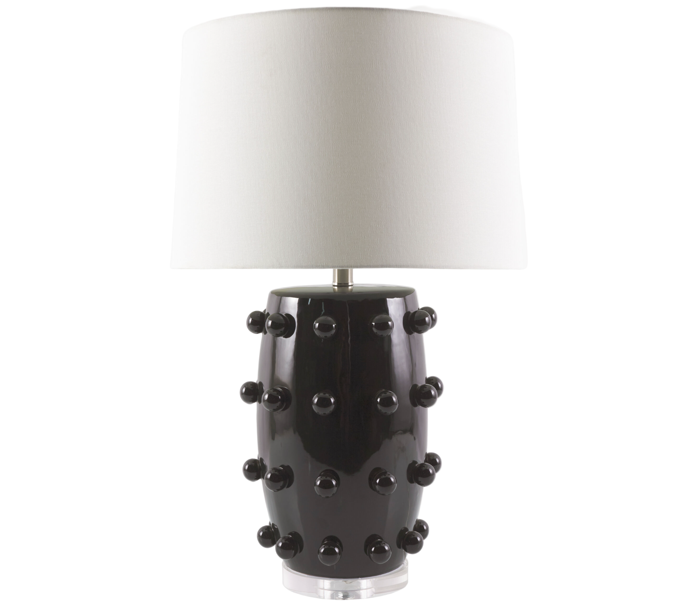 Black lamp with textured design and white shade on a white background