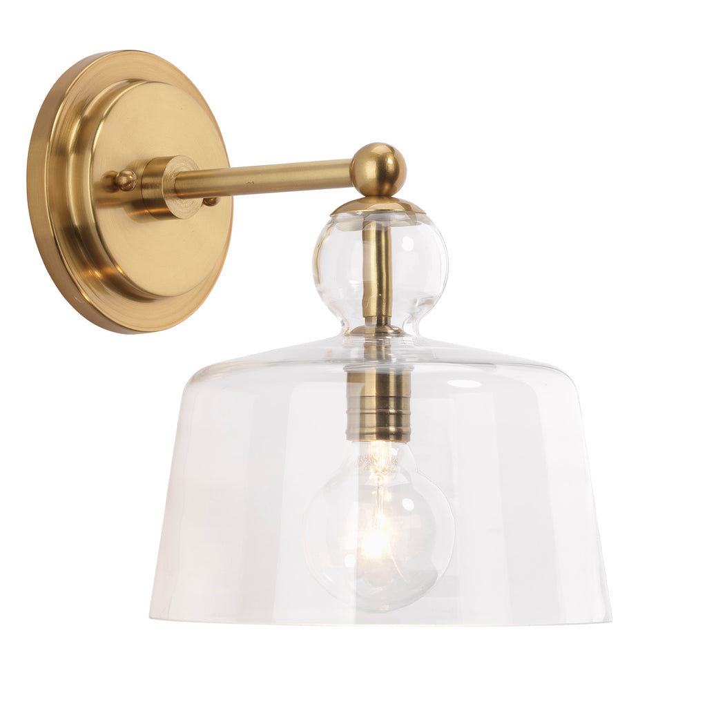 Hudson gold wall sconce on white wall.