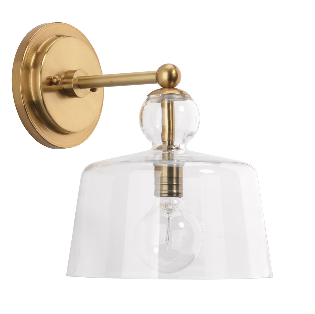 Hudson gold wall sconce on white wall.