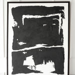 Solo black artwork on table with white wall behind
