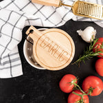 black and white stripe tea towels with garlic container tomatoes on marble countertop