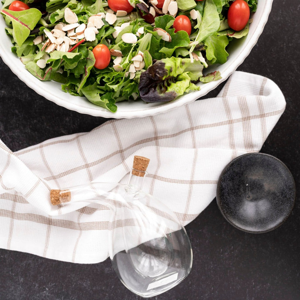 Linen Dish Towel next to bowl of salad with black background