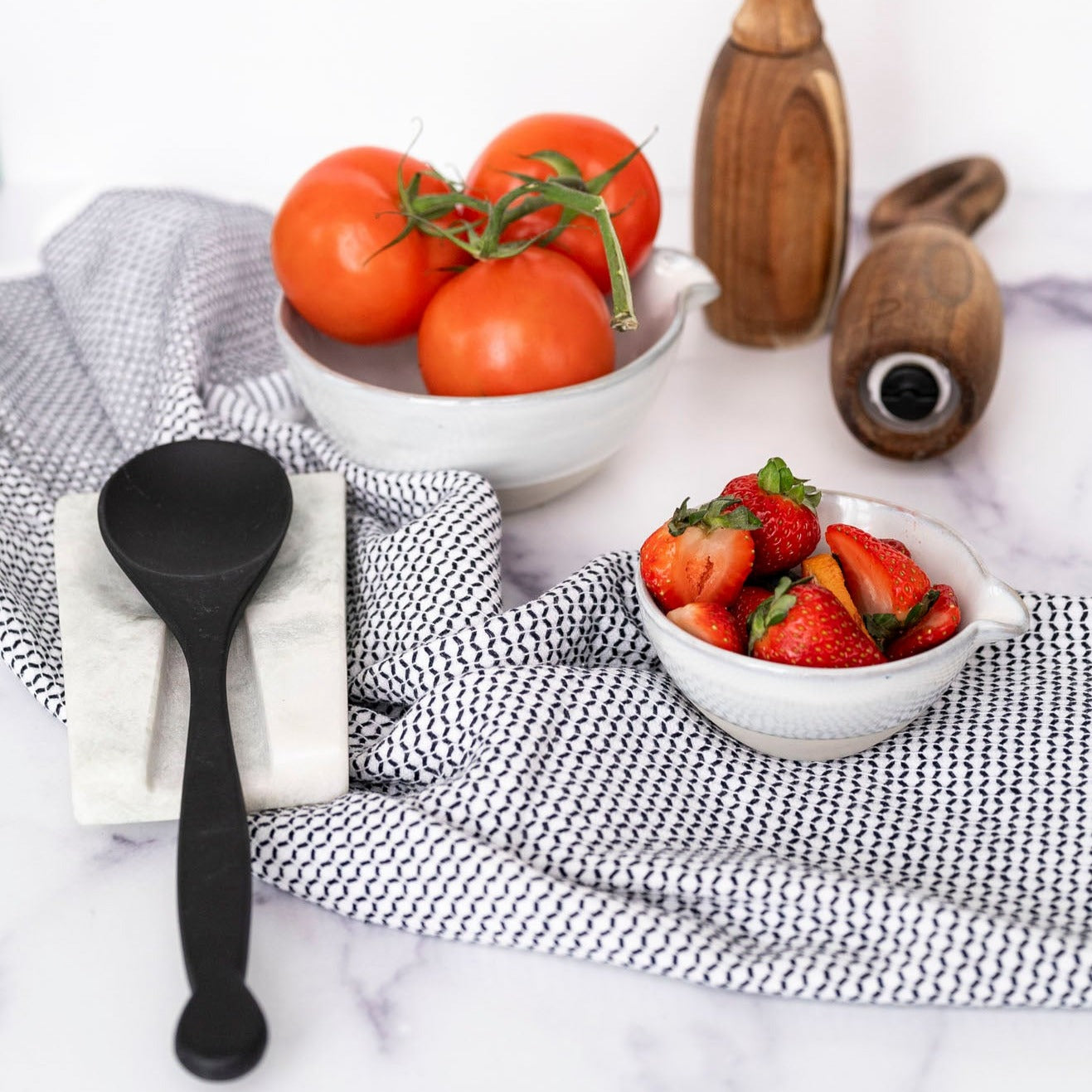 Marble Spoon Rest with black spoon and black and white towel with white background