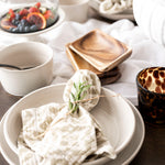 Shay Napkin on plate on wood table with white background