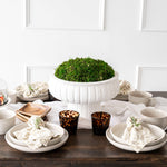 Shay Napkins on plates on wood table with white wall behind