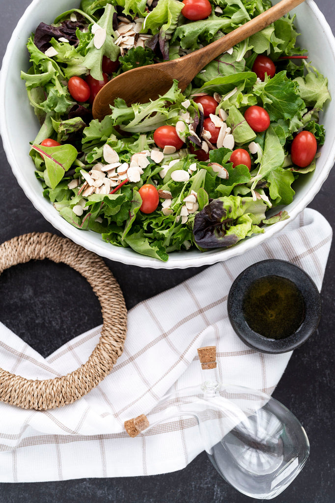 Rope trivet flatlay with salad and oil cruet