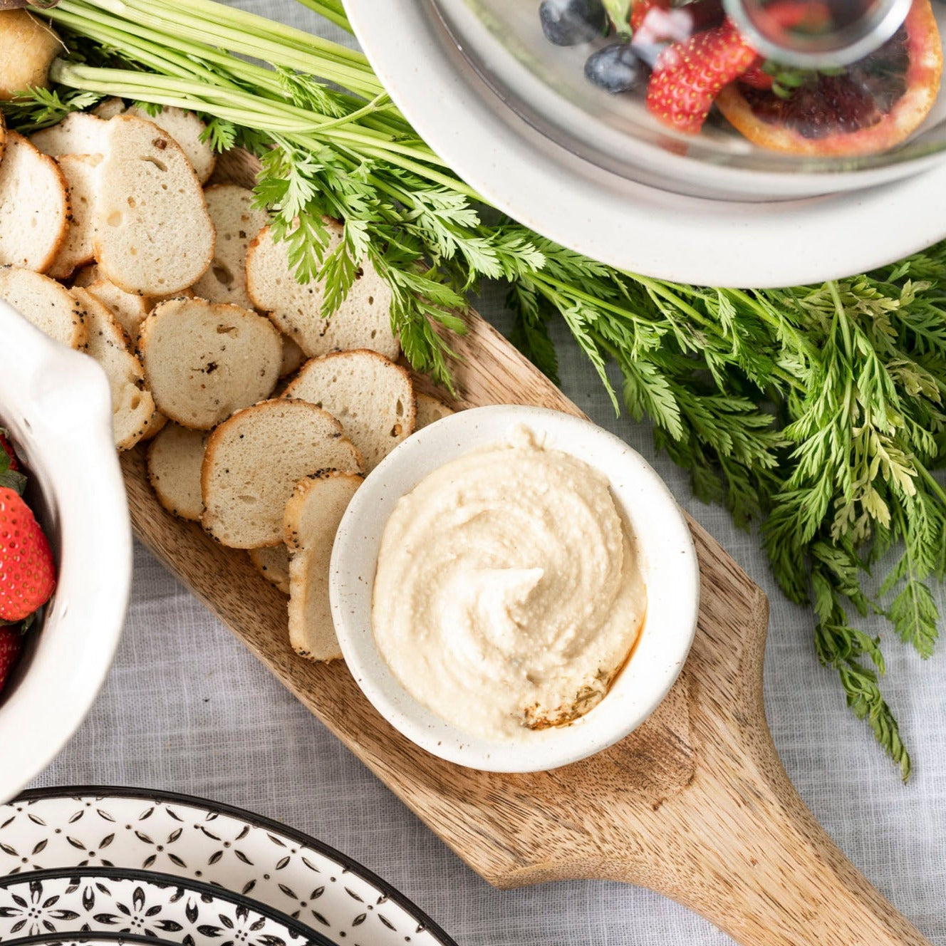 White stoneware bowl  filled with hummus 