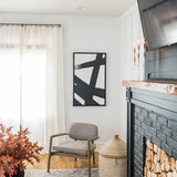 Black and white art set with black frames on white wall in house