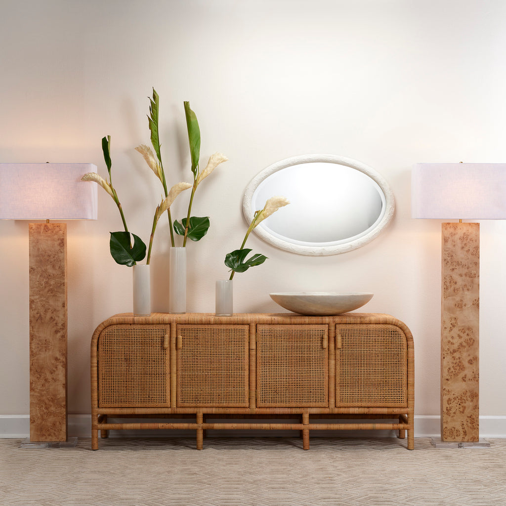 Ovation white oval mirror on wall in room over entryway table.